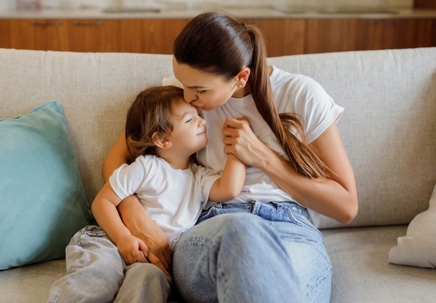 mother kissing son on the forehead