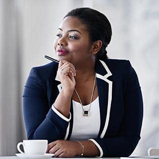 A women at a desk looking in the distance