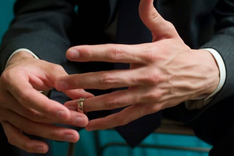 a man removing wedding ring from finger